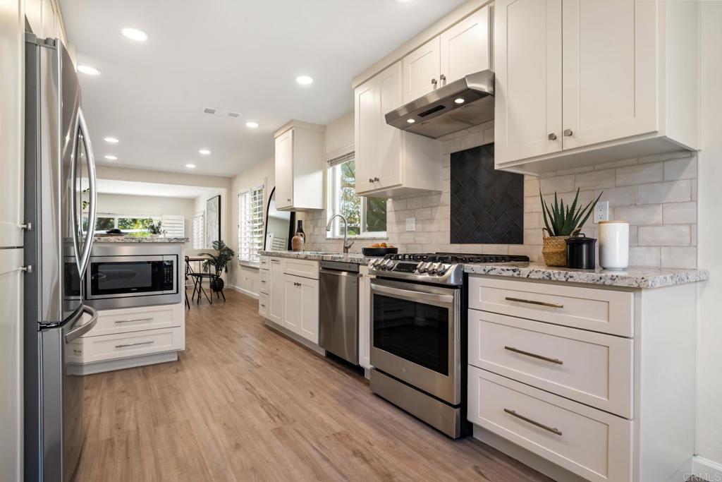 3163 Via De Caballo Encinitas, CA 92024 - Photo 6 of 23 a kitchen with stainless steel appliances granite countertop a stove and a sink