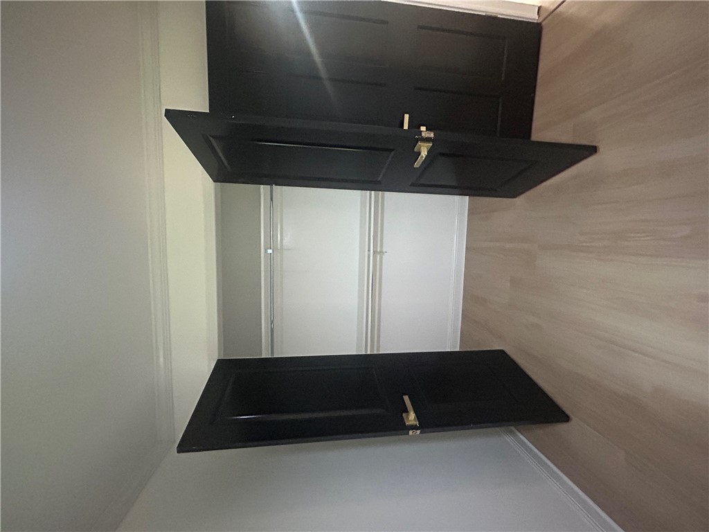 809 Paige Road Honea Path, SC 29654 - Photo 24 of 27 Ample closet space with elegant black doors complements light wood flooring.