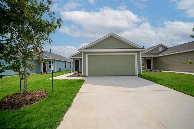 a front view of house with yard and green space