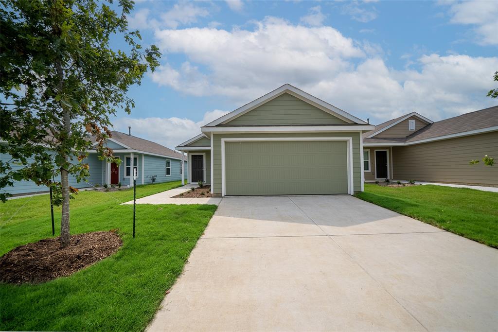 a front view of house with yard and green space