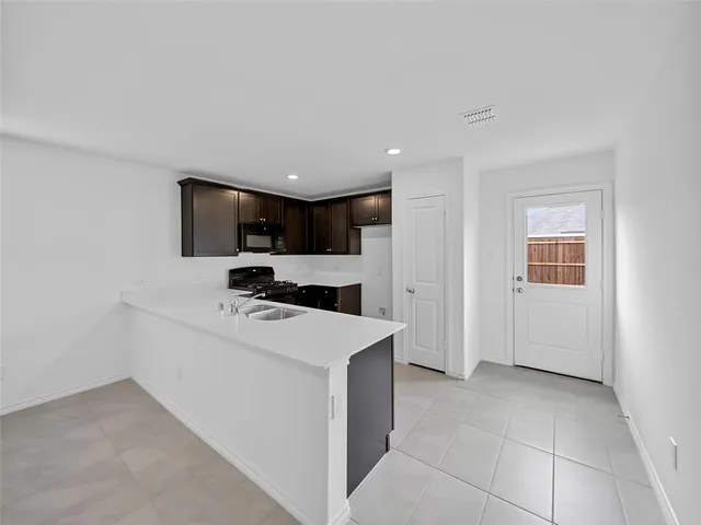 a kitchen with stainless steel appliances granite countertop a sink and a stove