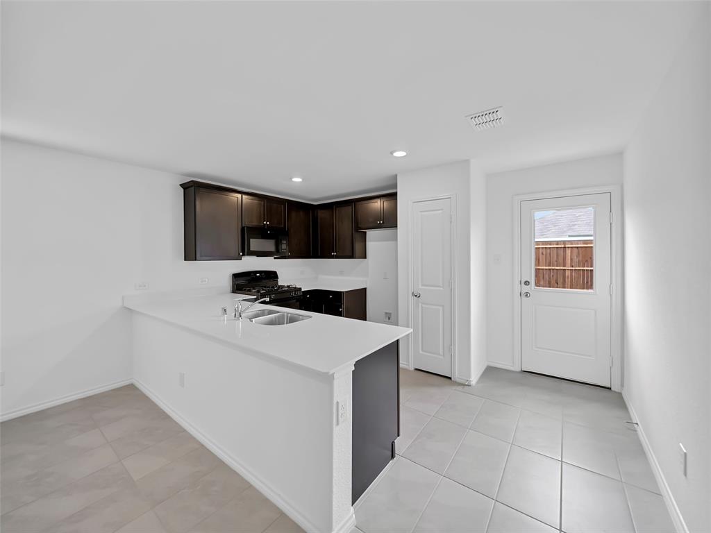 7765 Ruellia Road McKinney, TX 75071 - Photo 11 of 40 a view of a kitchen with a sink