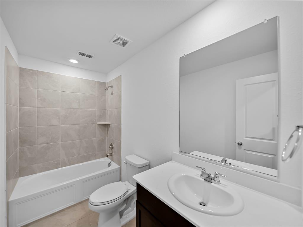 7765 Ruellia Road McKinney, TX 75071 - Photo 18 of 40 a bathroom with a sink toilet and shower