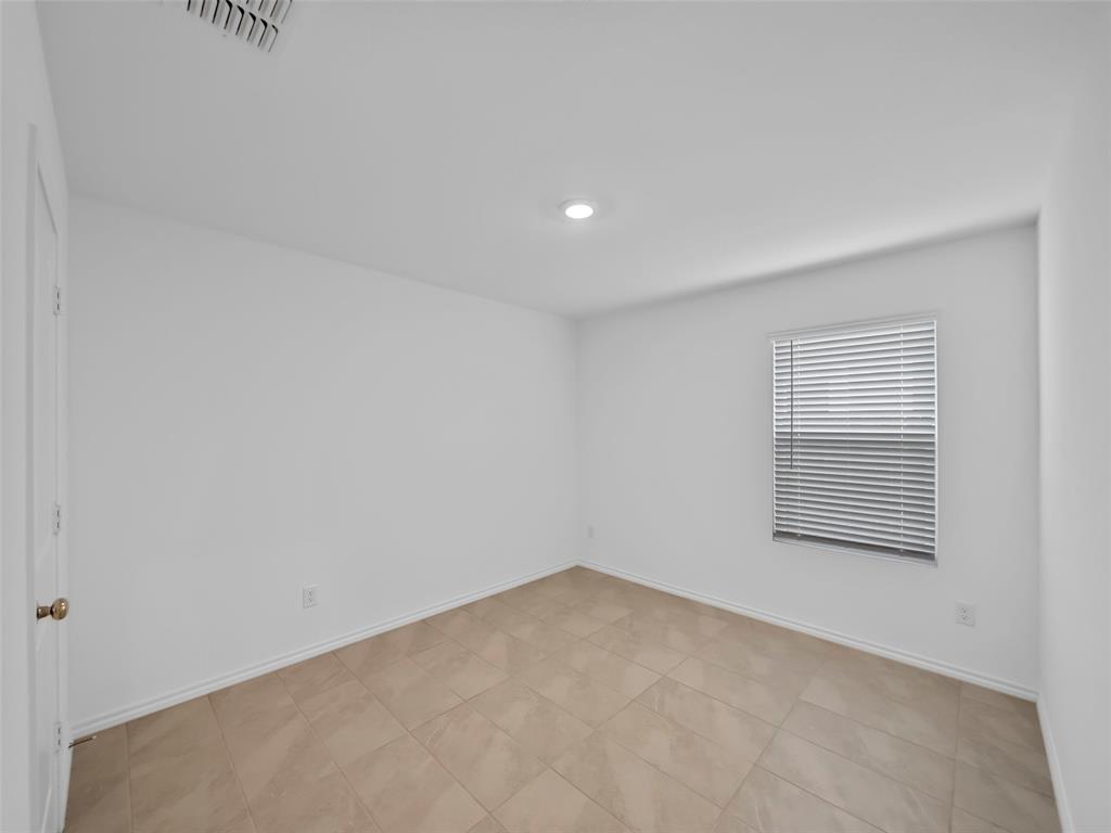 7765 Ruellia Road McKinney, TX 75071 - Photo 22 of 40 a view of an empty room with a window