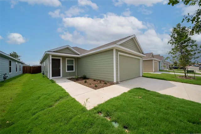 a front view of house with yard and green space