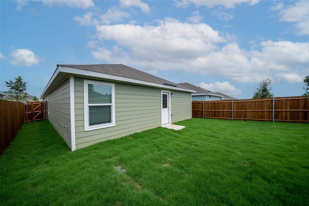 7765 Ruellia Road McKinney, TX 75071 - Photo 30 of 40 a view of a backyard with potted plants and wooden fence