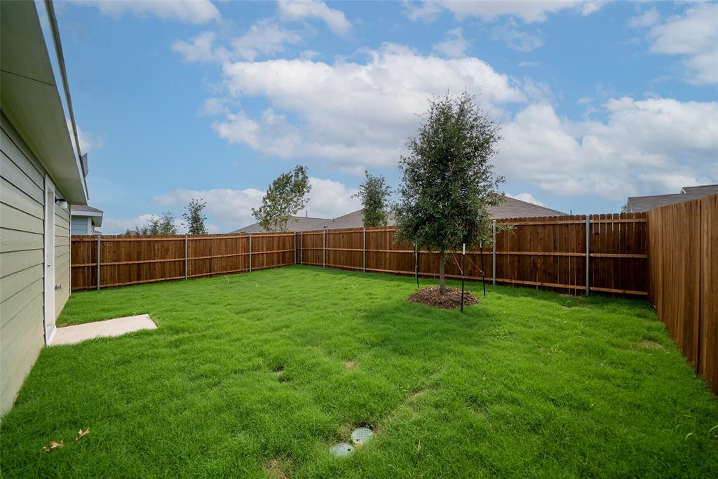 7765 Ruellia Road McKinney, TX 75071 - Photo 32 of 40 a view of a yard with a wooden fence