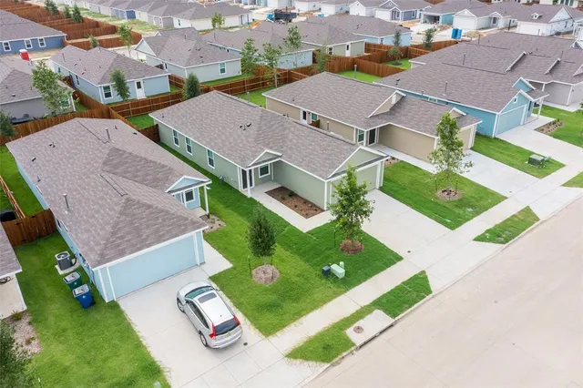an aerial view of residential house with yard