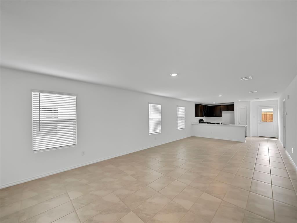 7765 Ruellia Road McKinney, TX 75071 - Photo 6 of 40 a view of an empty room with a window and a kitchen