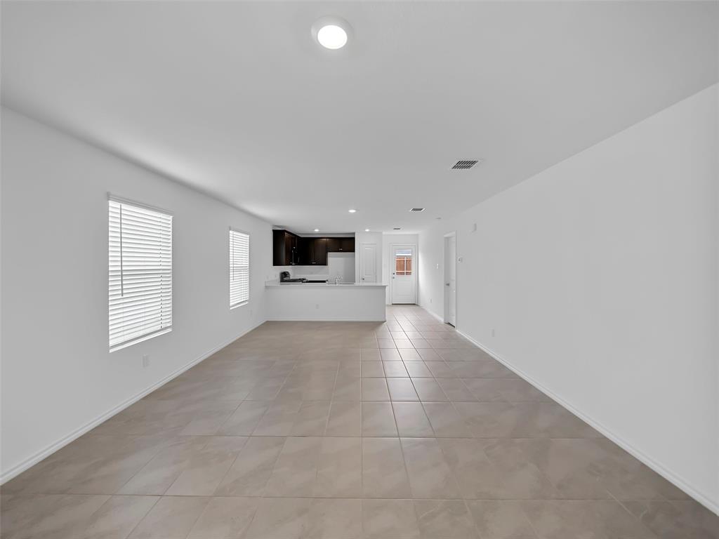 7765 Ruellia Road McKinney, TX 75071 - Photo 7 of 40 a view of open kitchen with a sink and dishwasher cabinets