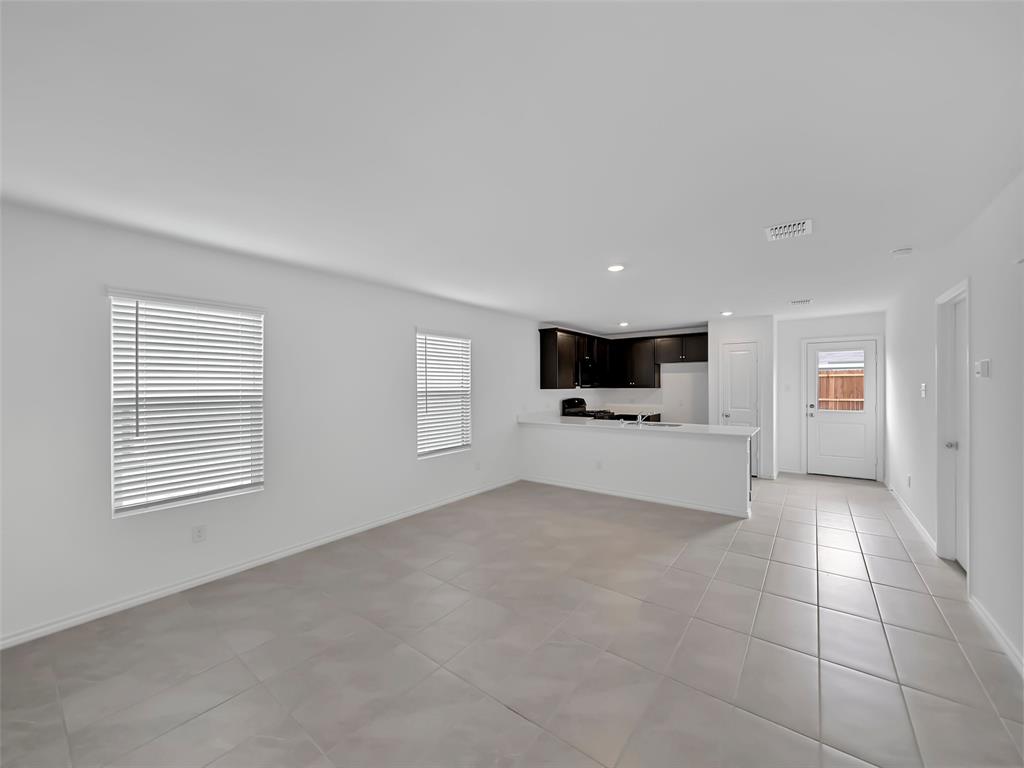 7765 Ruellia Road McKinney, TX 75071 - Photo 8 of 40 a view of empty room with a kitchen