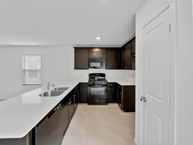 a hallway with a sink and a stove top oven