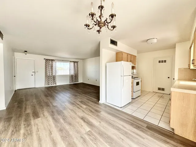a view of a kitchen with a sink and refrigerator
