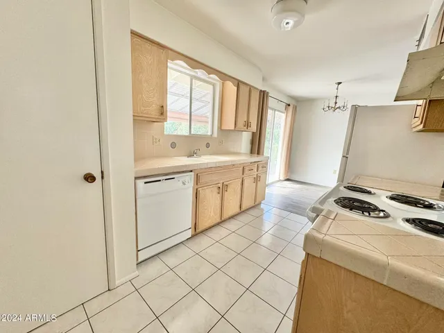 a kitchen with a stove a sink and a refrigerator