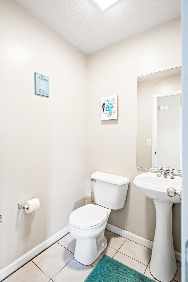 1109 East Shelbourne Drive Normal, IL 61761 - Photo 13 of 33 a white toilet sitting next to a bathroom sink