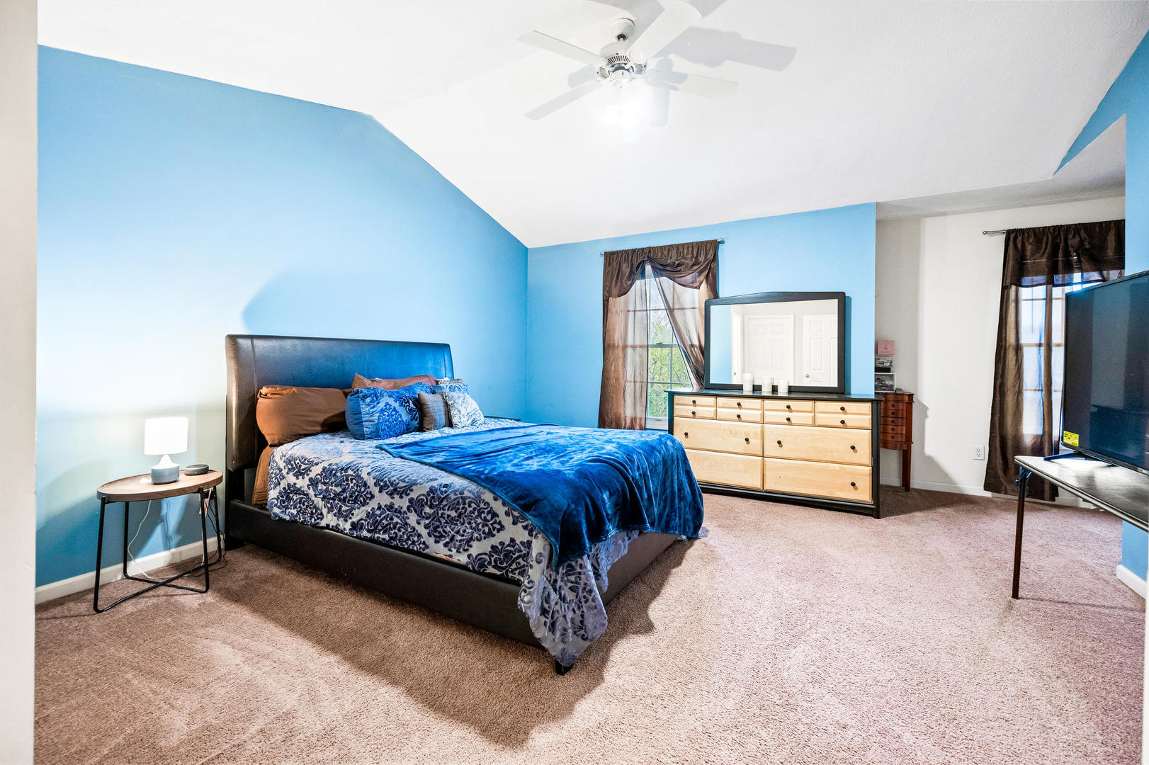 1109 East Shelbourne Drive Normal, IL 61761 - Photo 15 of 33 a spacious bedroom with a bed and dresser with mirror
