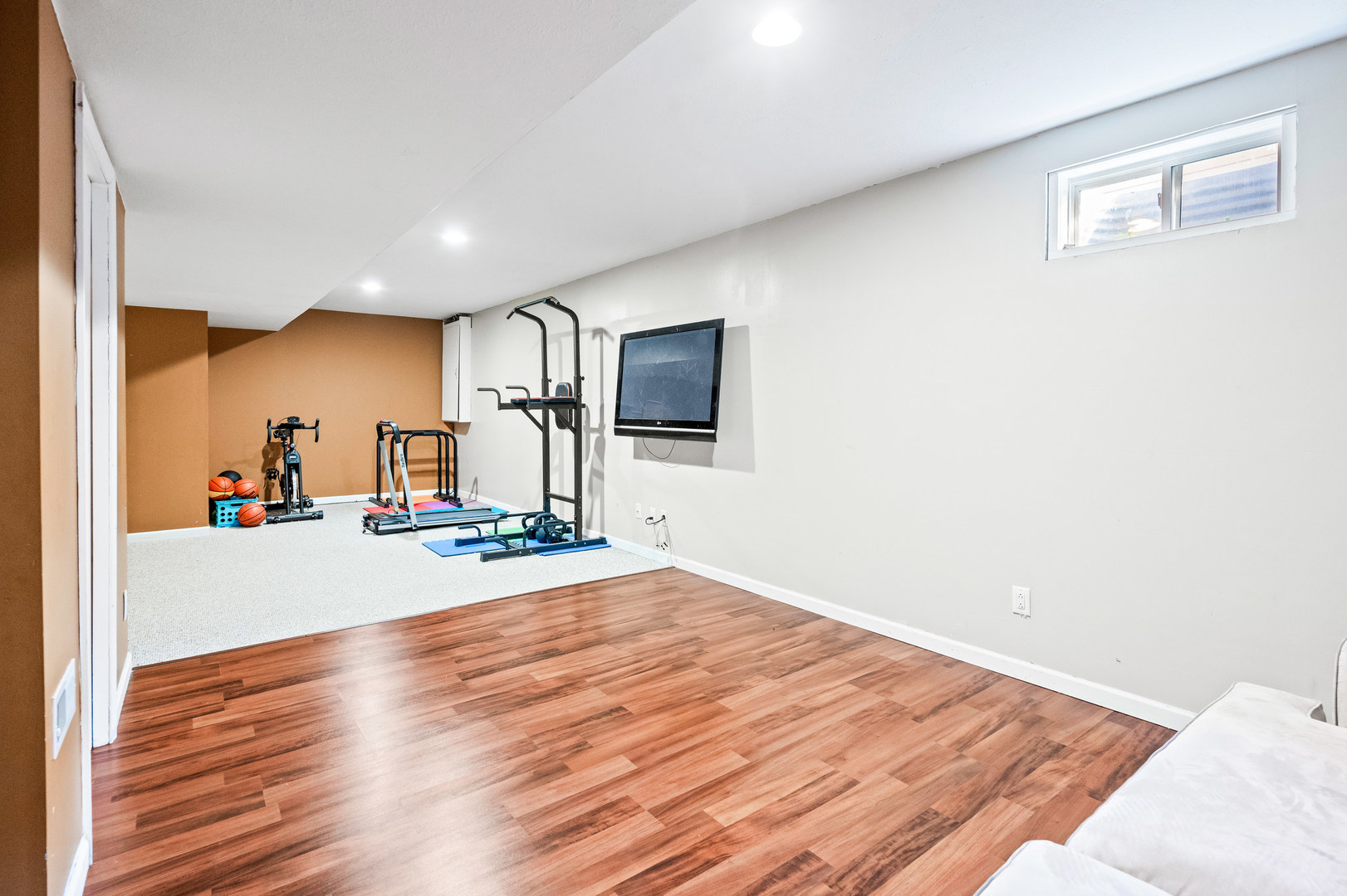 1109 East Shelbourne Drive Normal, IL 61761 - Photo 26 of 33 a view of a livingroom with wooden floor and a flat screen tv