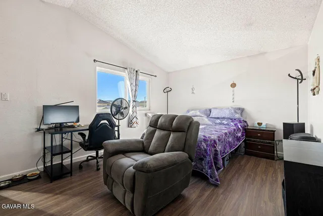 a bedroom with furniture and a wooden floor
