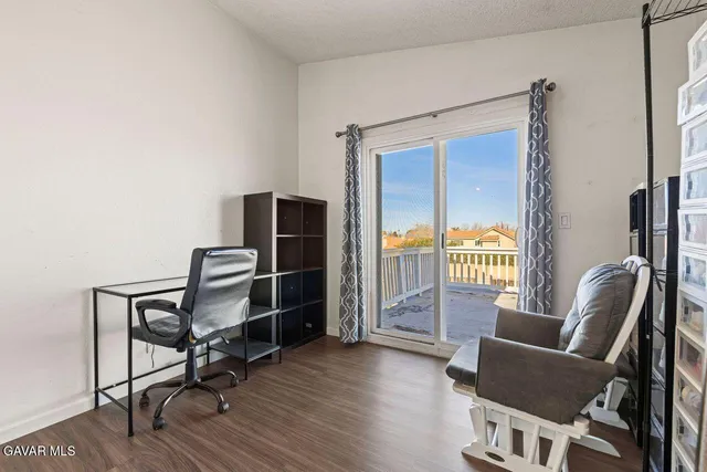 a view of a workspace with furniture and a window
