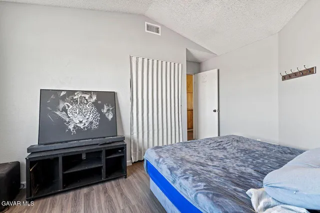 a bedroom with a bed and a dresser