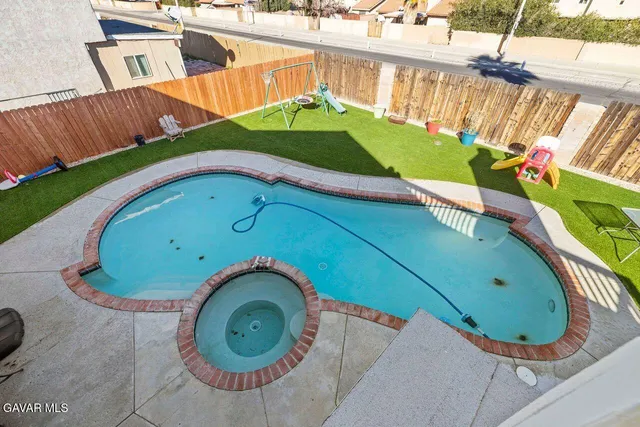 a view of a swimming pool with a yard