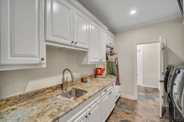 a kitchen with stainless steel appliances granite countertop a sink and cabinets