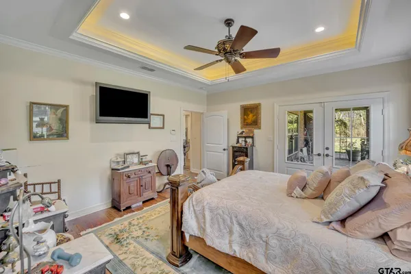 a bed room with a bed a television and a dresser