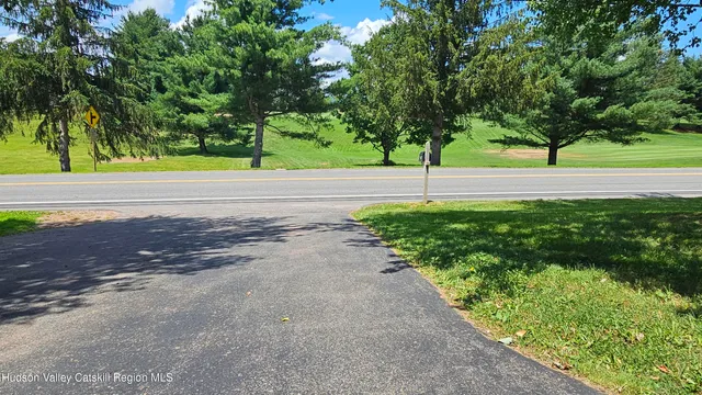 a view of a field of grass and trees