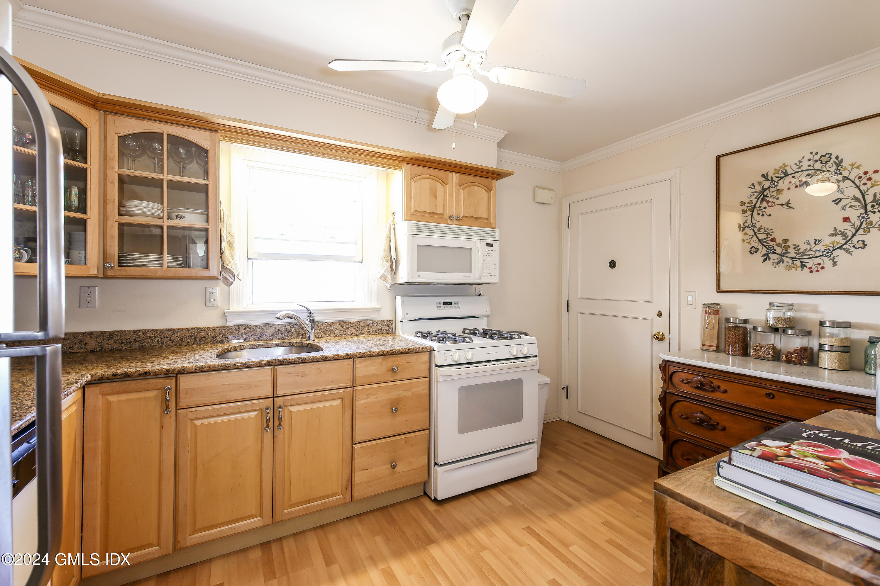 49 Valley Road, Unit D1 Cos Cob, CT 06807 - Photo 4 of 11 a kitchen with stainless steel appliances granite countertop a stove a sink and a microwave