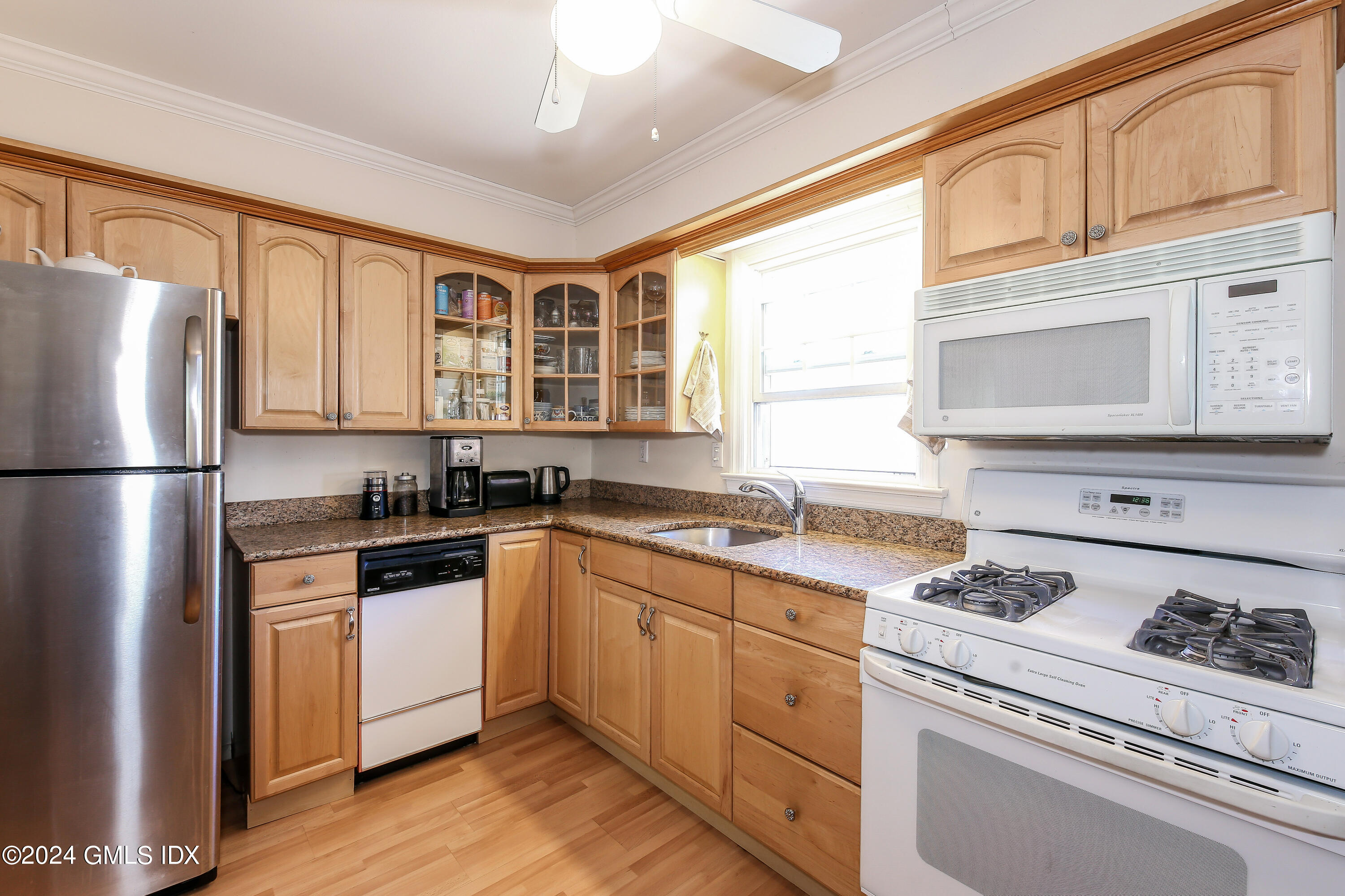 49 Valley Road, Unit D1 Cos Cob, CT 06807 - Photo 6 of 11 a kitchen with stainless steel appliances granite countertop a stove a sink dishwasher a refrigerator white cabinets and wooden floor