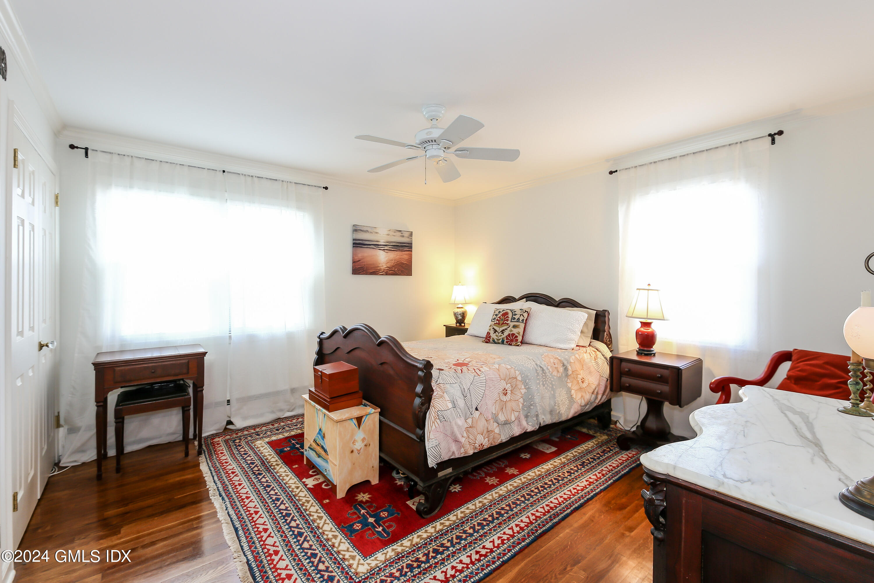 49 Valley Road, Unit D1 Cos Cob, CT 06807 - Photo 7 of 11 a bedroom with bed and a chandelier