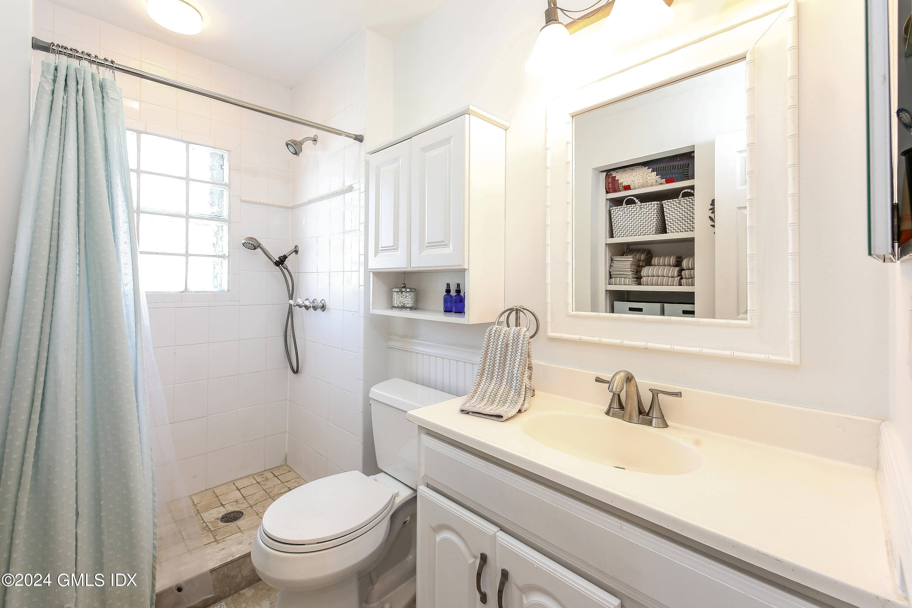 49 Valley Road, Unit D1 Cos Cob, CT 06807 - Photo 8 of 11 a bathroom with a sink toilet vanity and shower