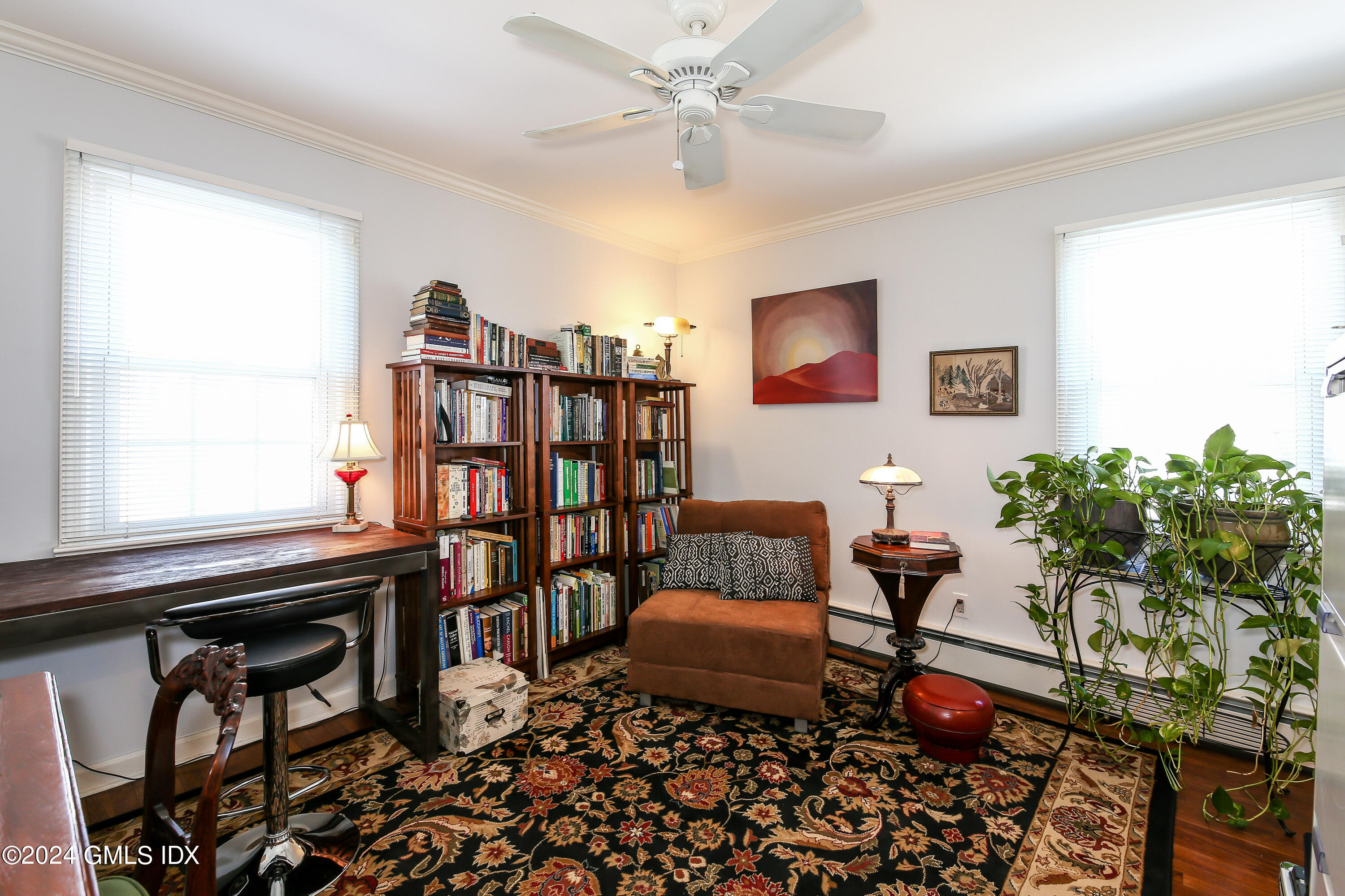 49 Valley Road, Unit D1 Cos Cob, CT 06807 - Photo 9 of 11 a living room with furniture a bookshelf and a window