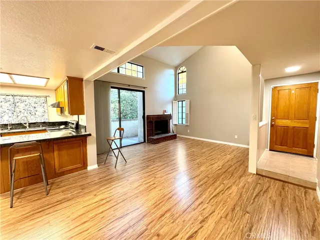 a view of a living room kitchen with a large window