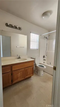 a spacious bathroom with a tub sink and mirror
