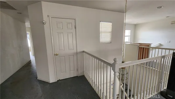 a view of a livingroom with furniture window wooden floor and windows