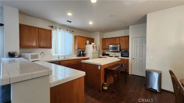 a kitchen with a sink a stove a refrigerator and a stove