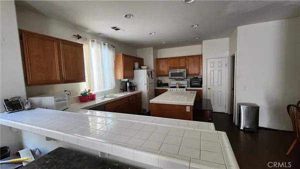a kitchen with stainless steel appliances a sink stove and refrigerator