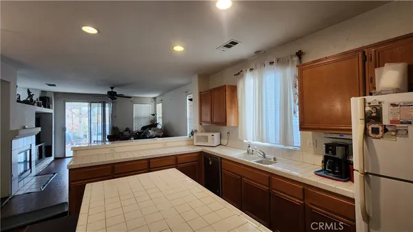 a large kitchen with kitchen island a sink stainless steel appliances and cabinets