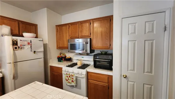a kitchen with stainless steel appliances a refrigerator stove and microwave