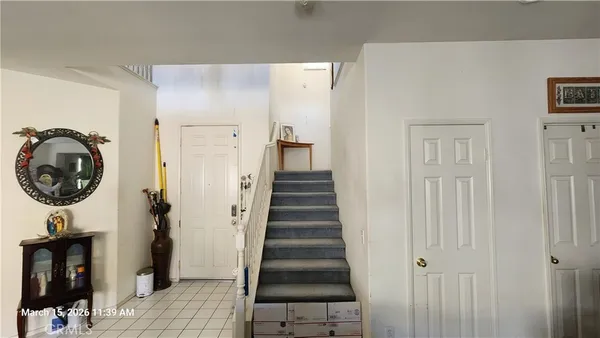 a view of a hallway with entryway and hall with wooden floor
