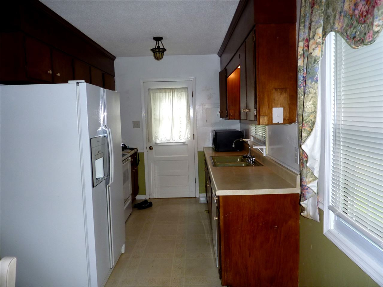7201 Perry Creek Road Raleigh, NC 27616 - Photo 5 of 16 Kitchen offers lots of cabinets, electric appliances, and a large 2 bay sink. Kitchen