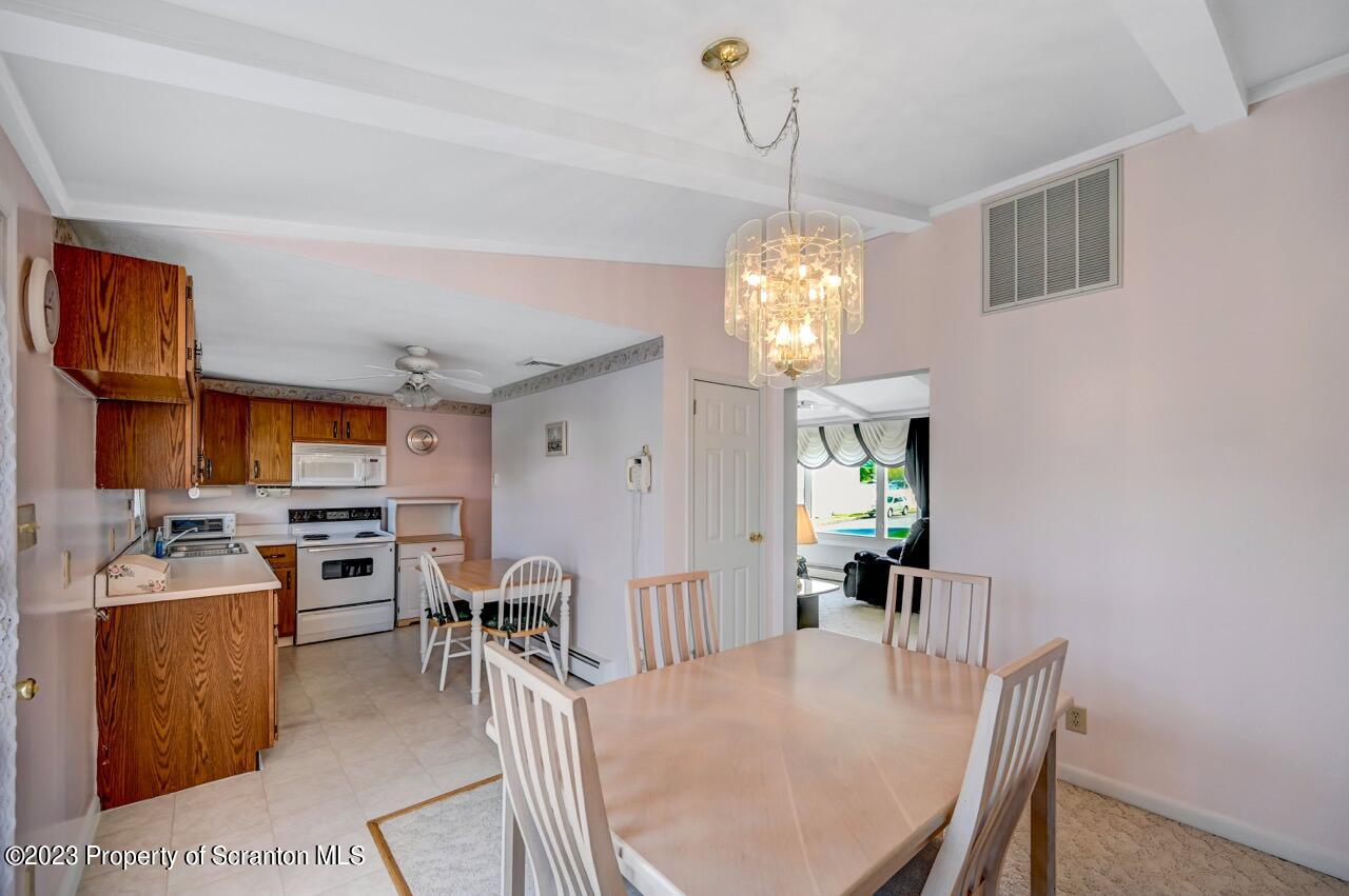 602 Eynon Street Scranton, PA 18504 - Photo 19 of 80 a view of a dining room with furniture a chandelier and wooden floor