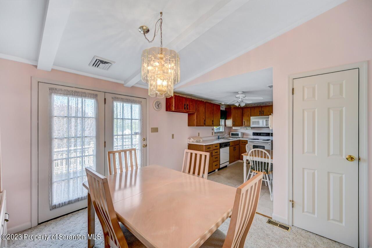 602 Eynon Street Scranton, PA 18504 - Photo 20 of 80 a view of a dining room with furniture a chandelier and wooden floor