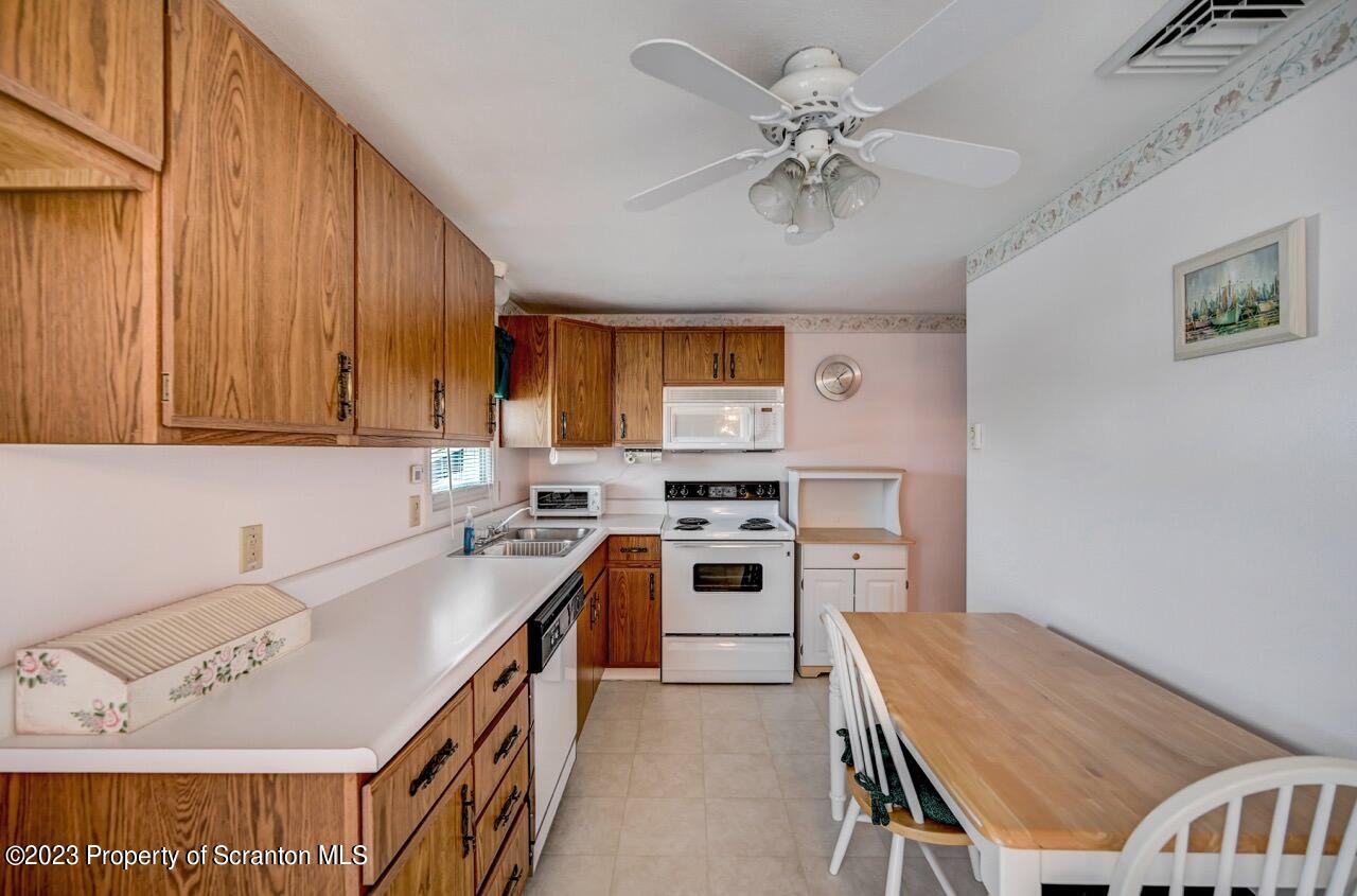 602 Eynon Street Scranton, PA 18504 - Photo 22 of 80 a kitchen with a stove a sink and a refrigerator