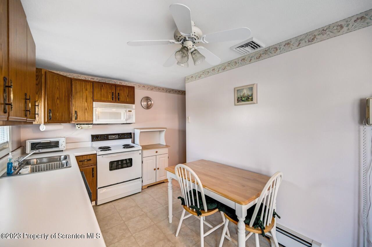 602 Eynon Street Scranton, PA 18504 - Photo 23 of 80 a kitchen with a stove a table and chairs