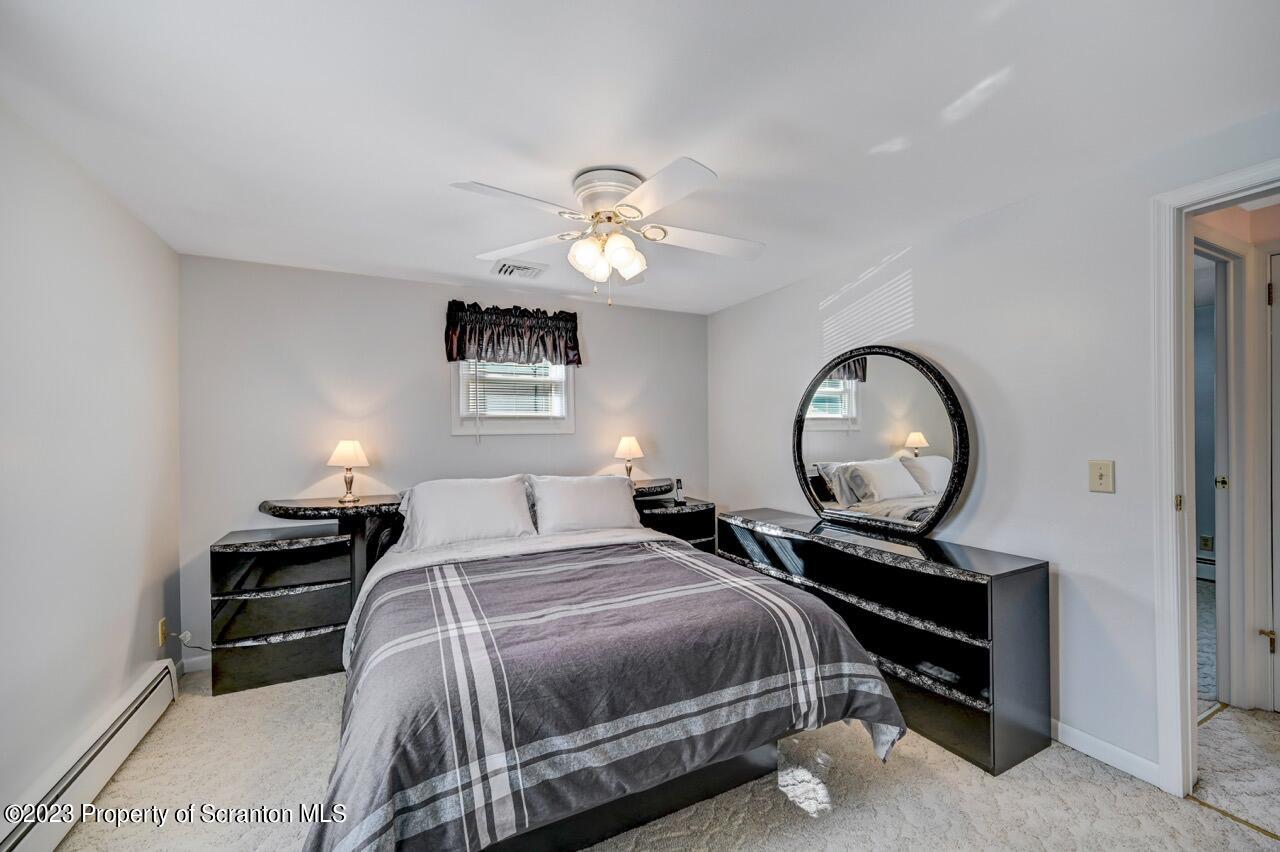 602 Eynon Street Scranton, PA 18504 - Photo 28 of 80 a bedroom with a bed and a chandelier