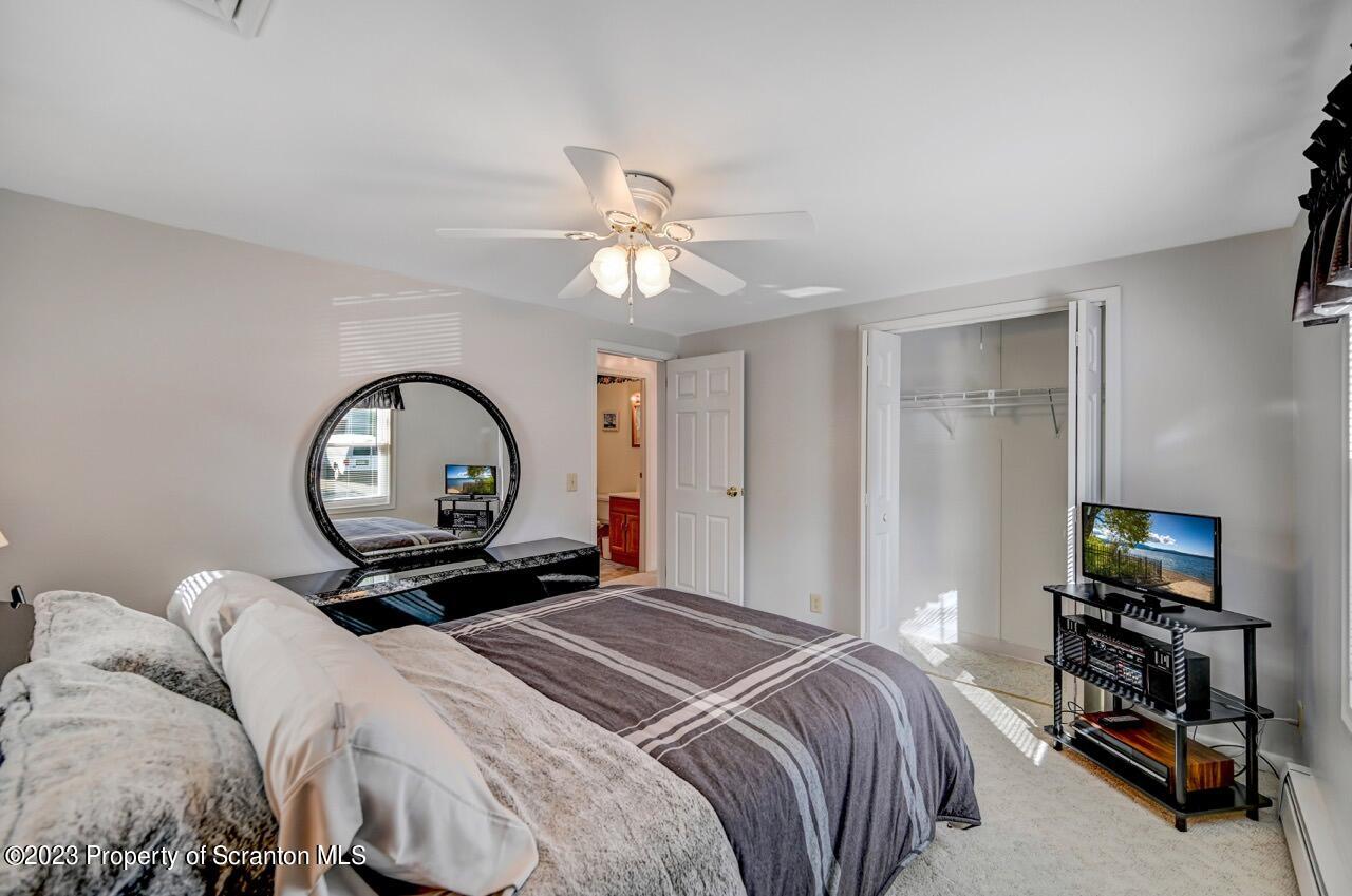 602 Eynon Street Scranton, PA 18504 - Photo 29 of 80 a bedroom with a bed and a chandelier