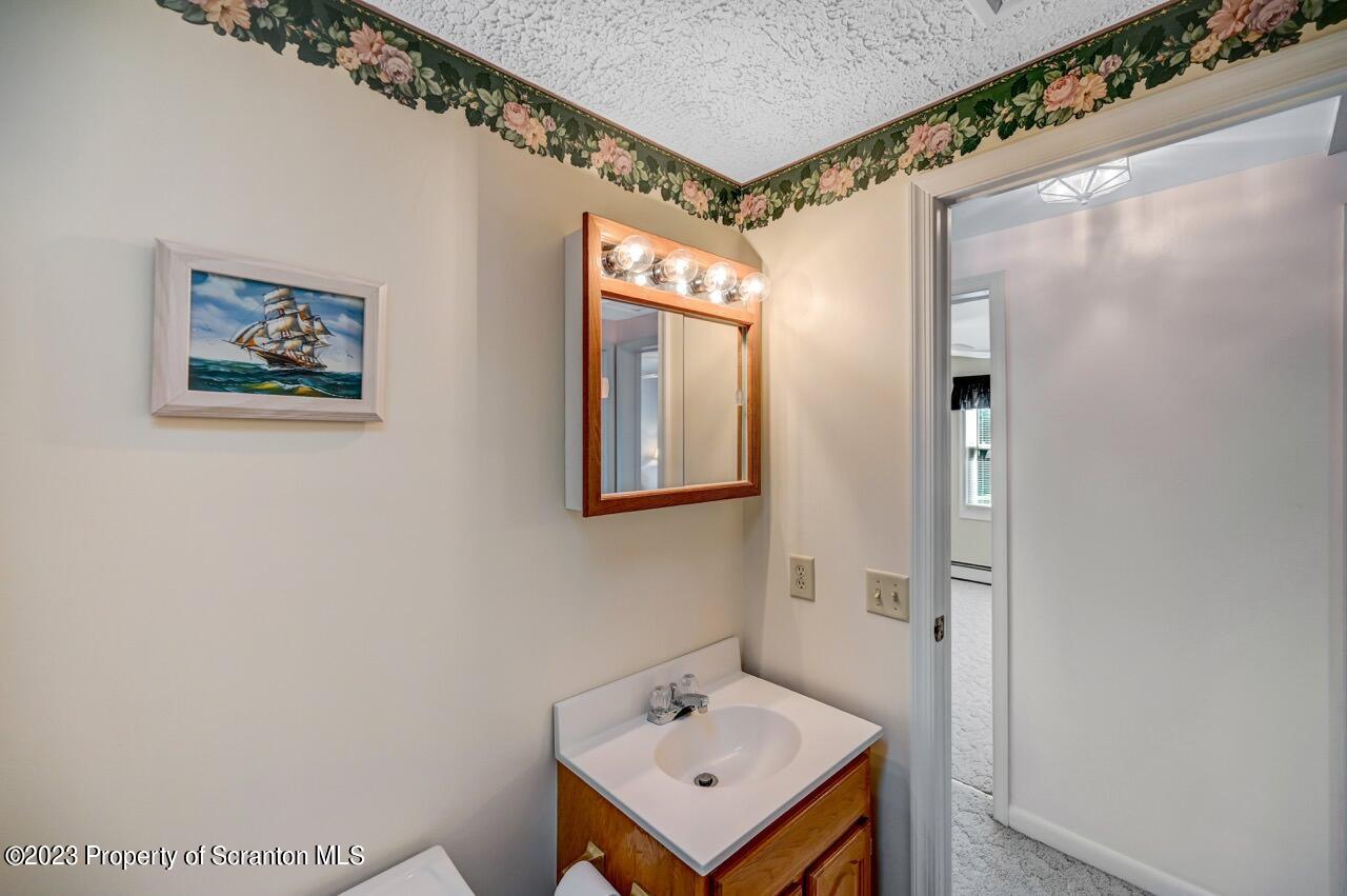 602 Eynon Street Scranton, PA 18504 - Photo 32 of 80 a bathroom with a sink mirror and a shower