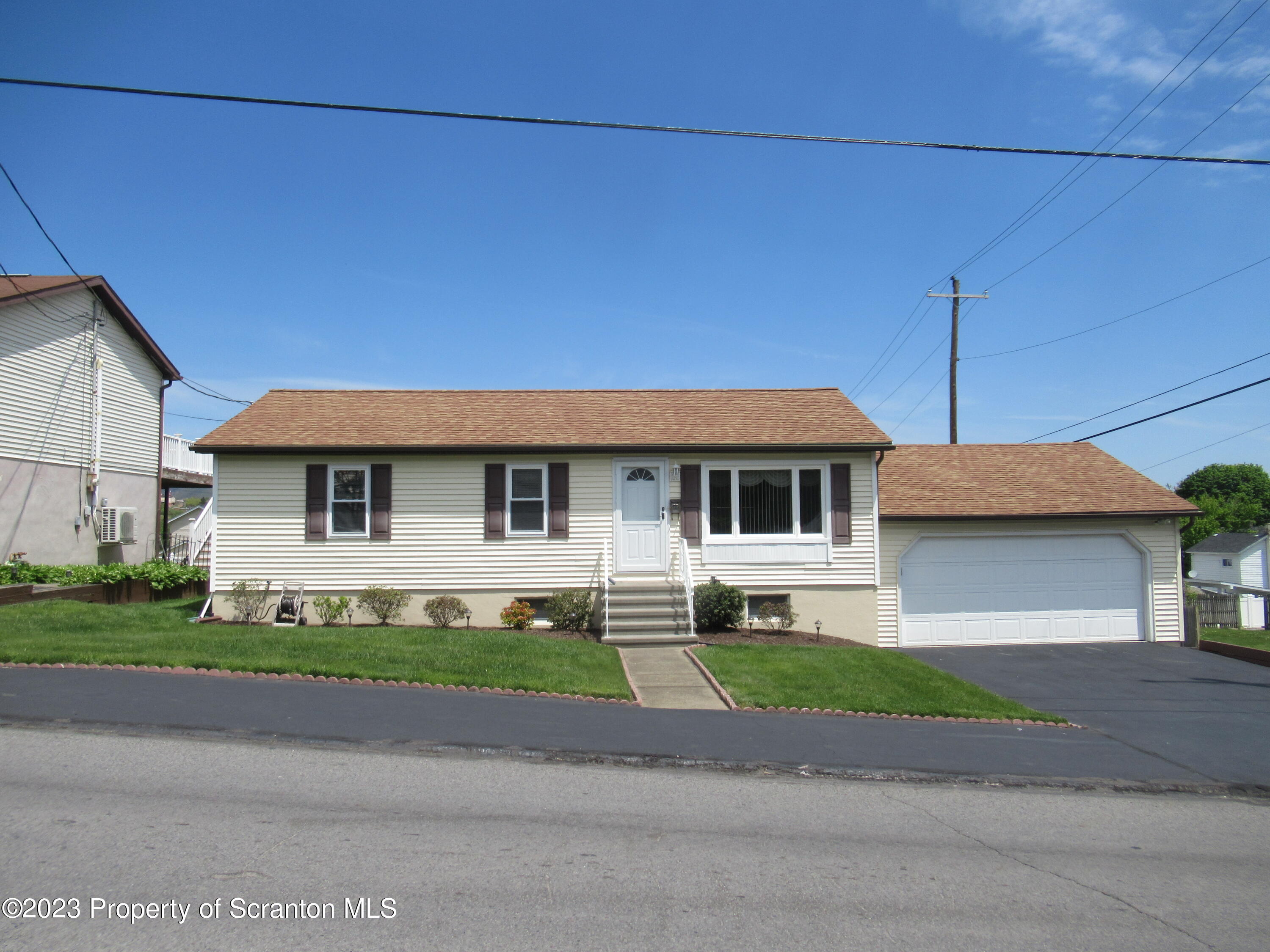 602 Eynon Street Scranton, PA 18504 - Photo 65 of 80 a front view of a house with a garden and yard